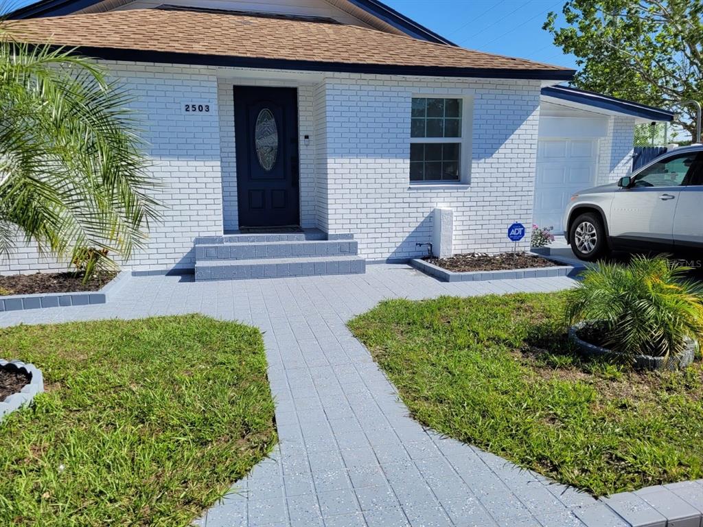 a front view of a house with garden