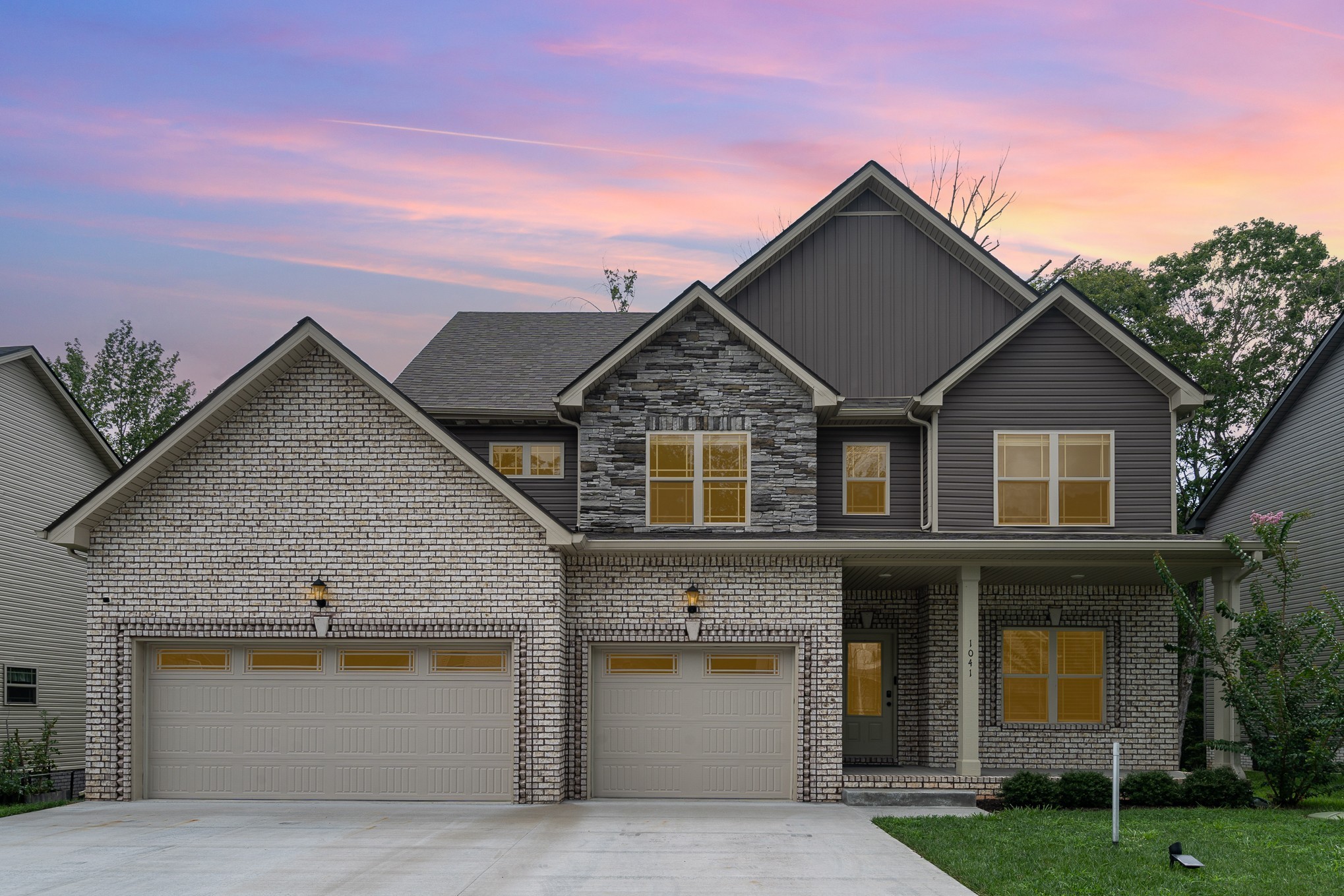 a front view of a house with a yard and garage