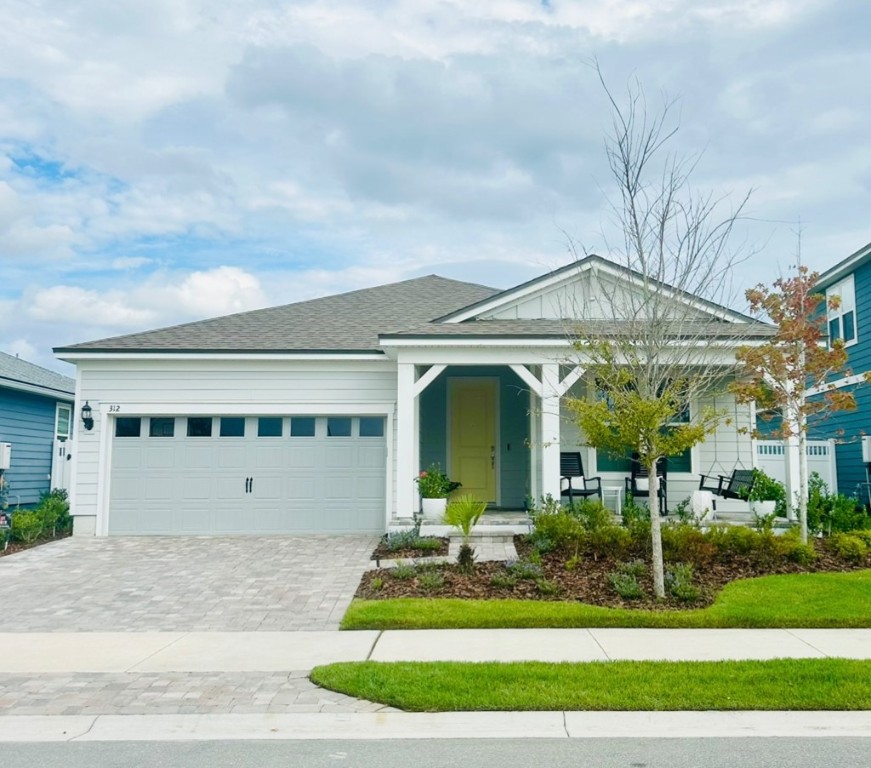 a front view of a house with a garden