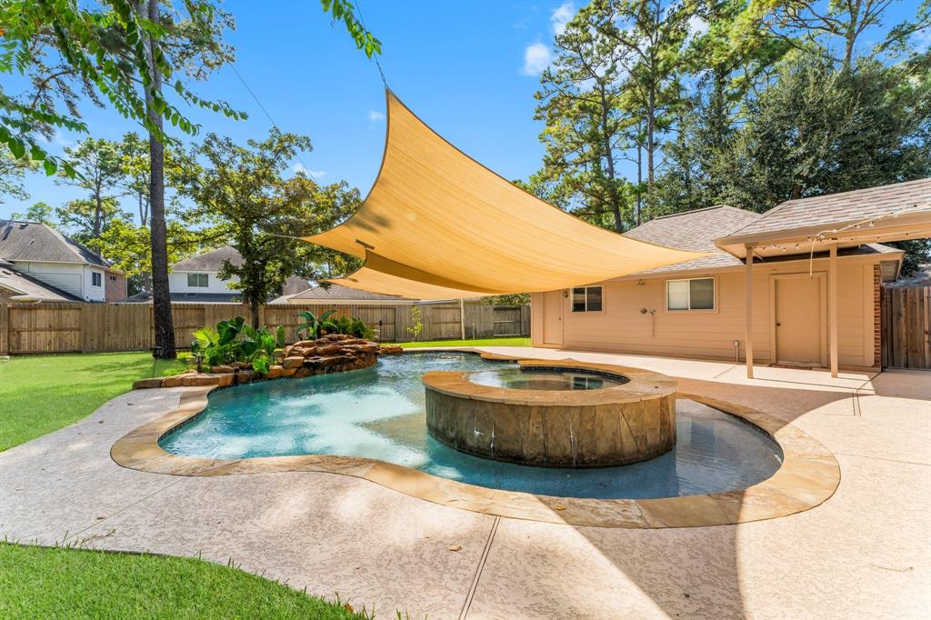 a swimming pool with patio outdoor seating and yard