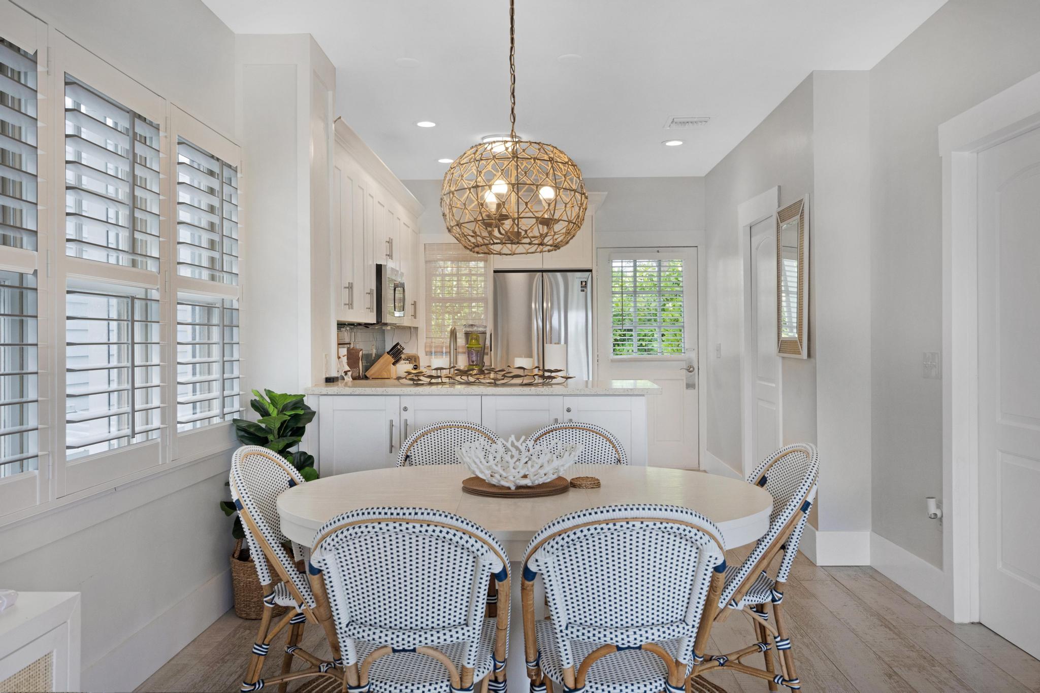 a dining room with furniture a chandelier and wooden floor