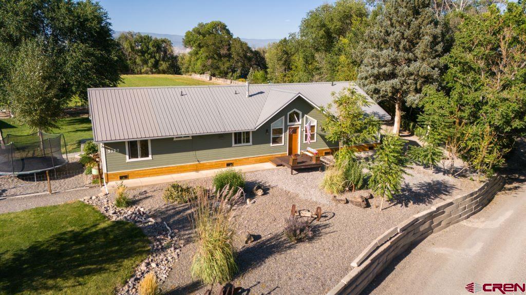 an aerial view of a house with a yard basket ball court and outdoor seating