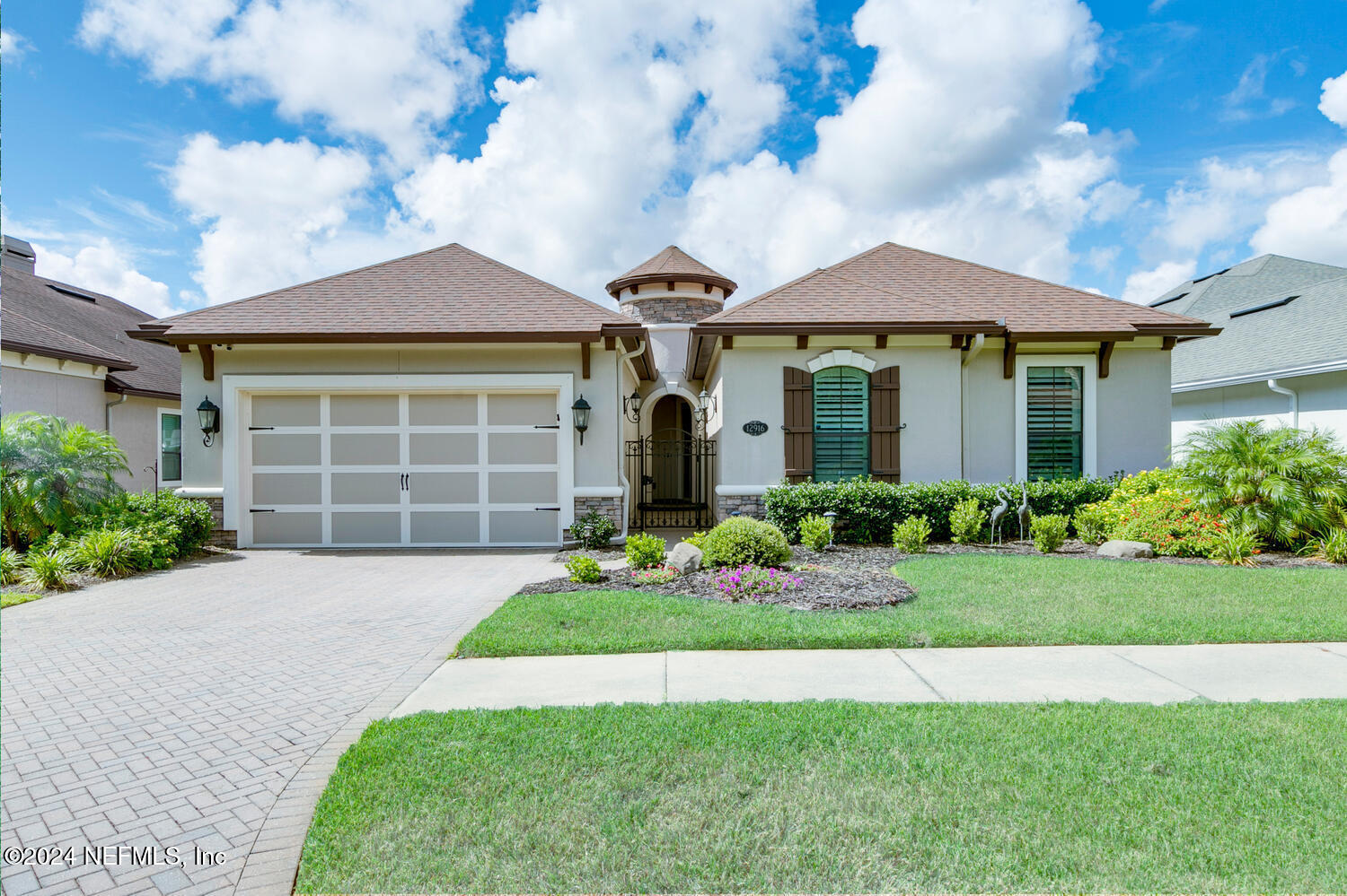 a front view of a house with a garden