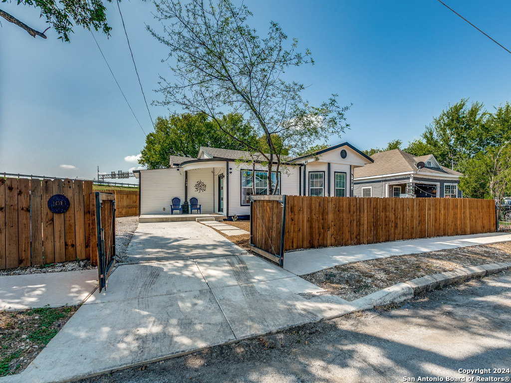 a view of a house with a yard and garage