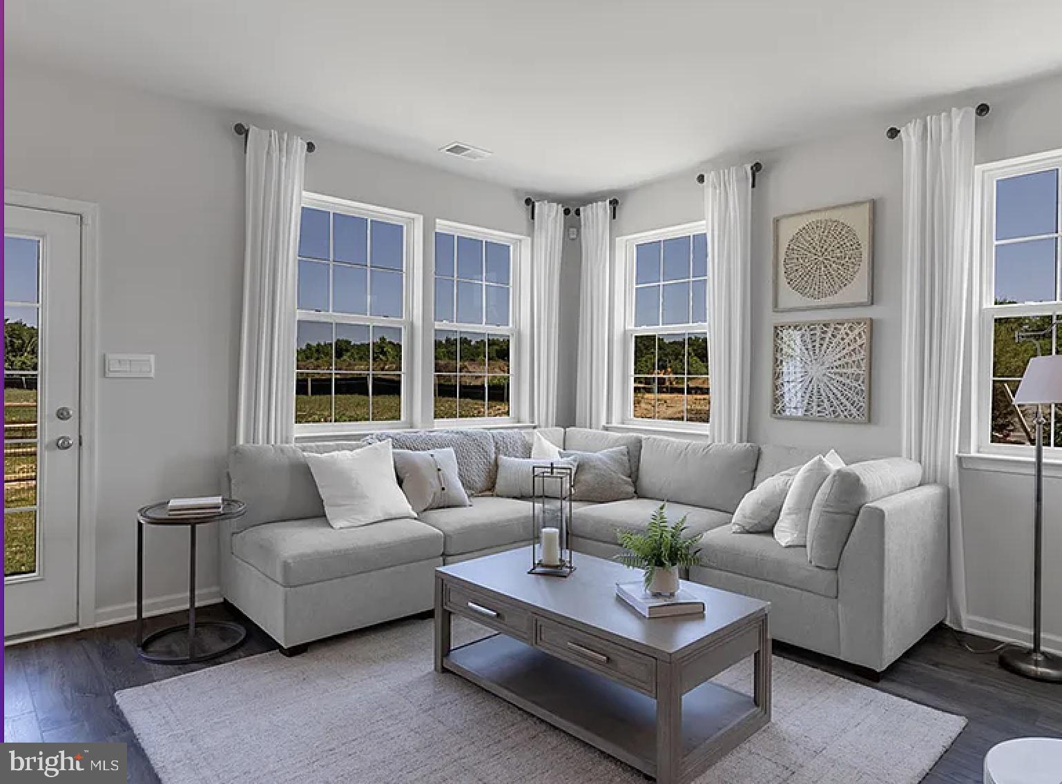 a living room with furniture and windows