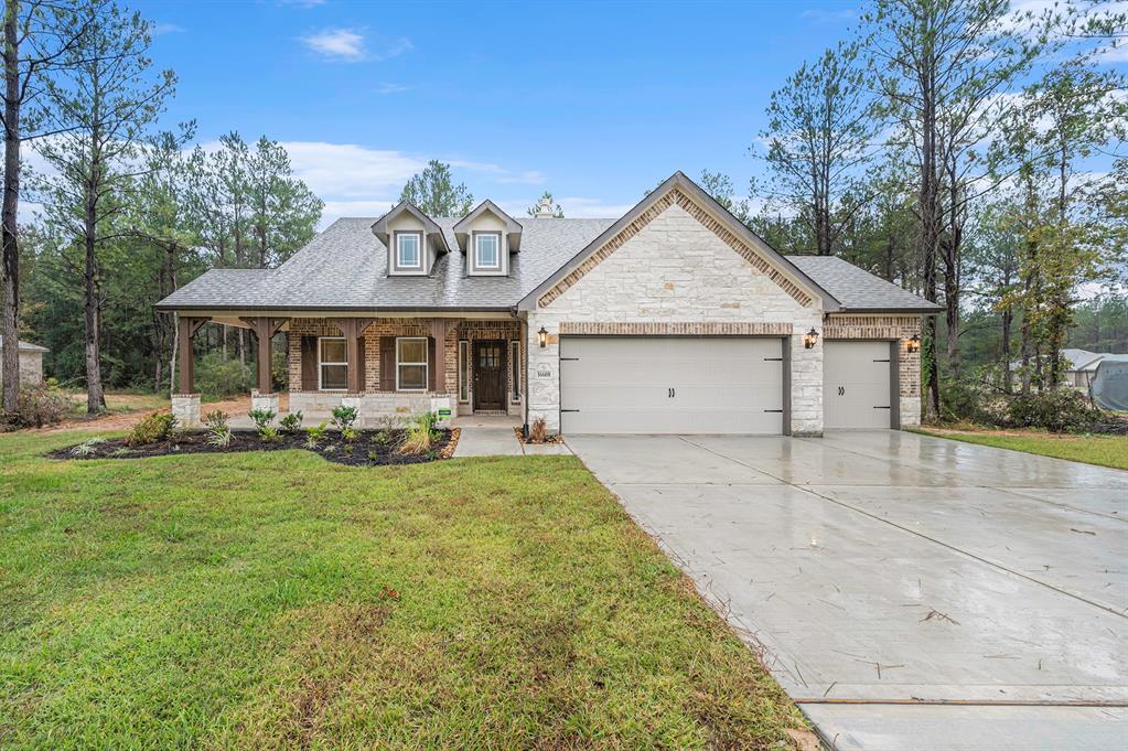 a front view of a house with yard patio and green space