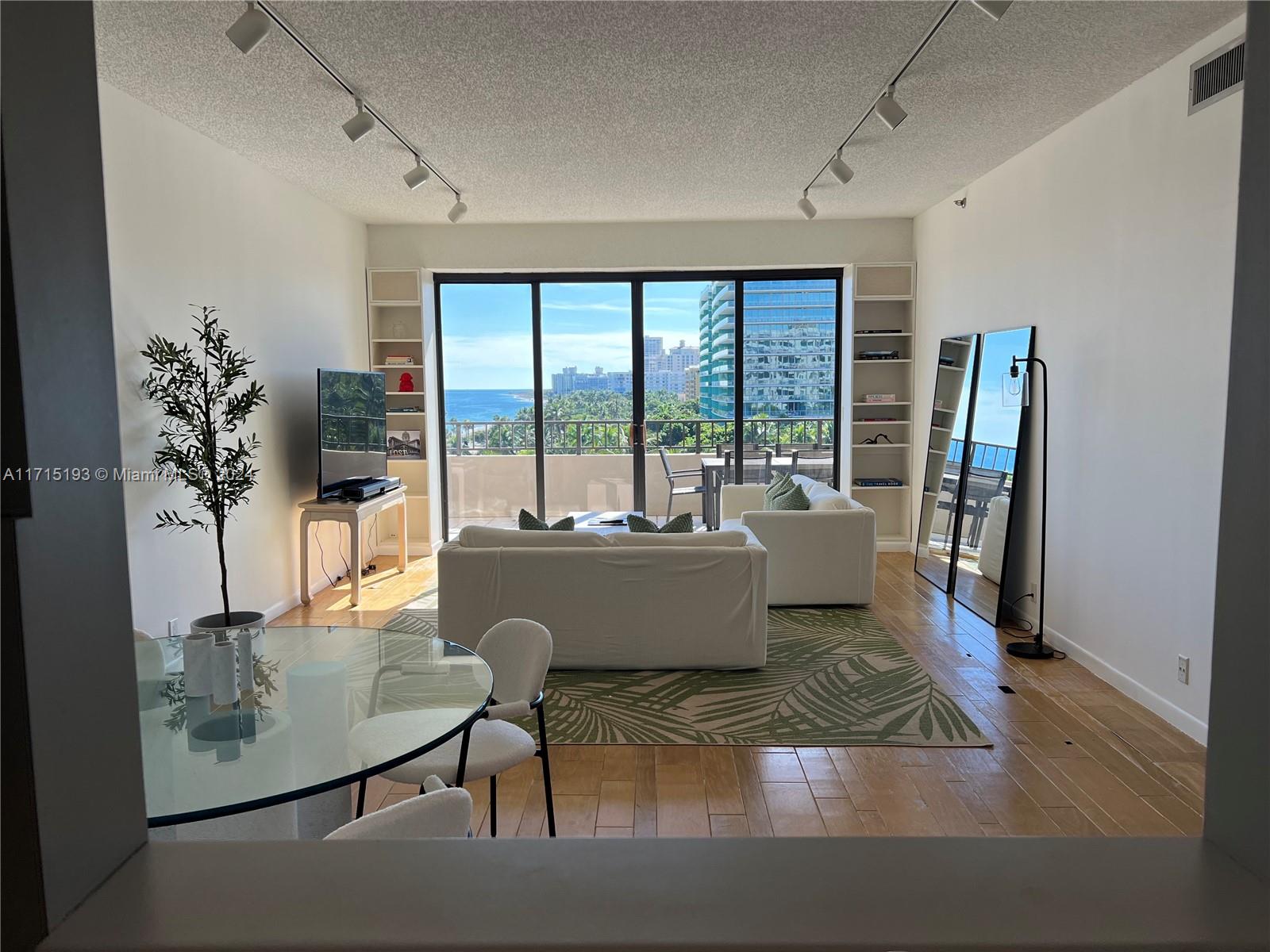 a living room with large window furniture and floor to ceiling window