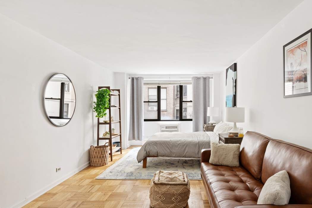 a living room with furniture fireplace and a large window