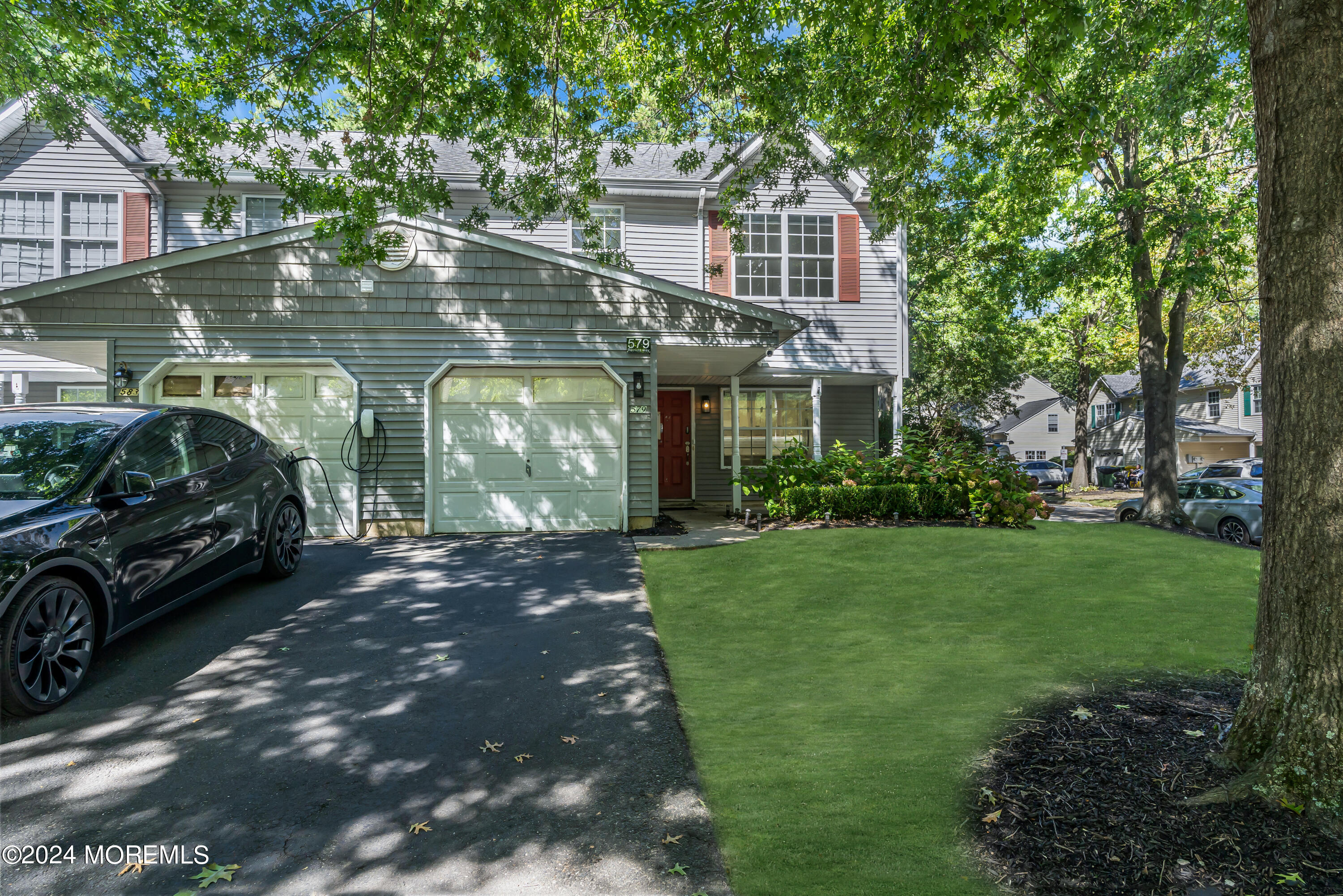 a front view of a house with a garden