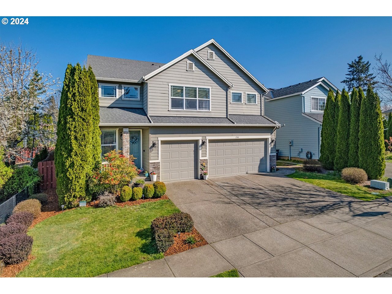 a front view of a house with a yard and garage