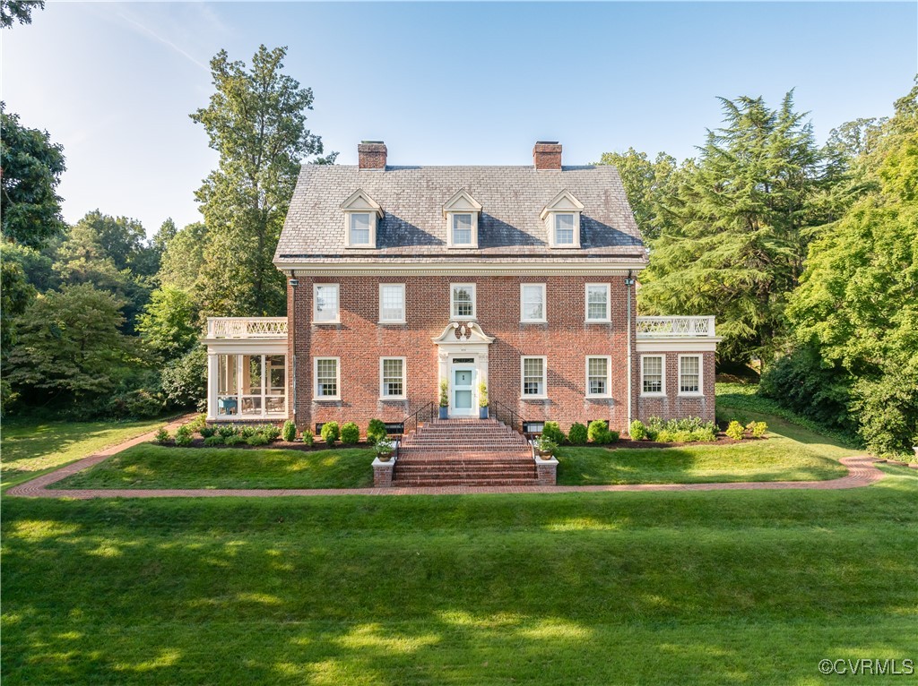 a front view of a house with a garden