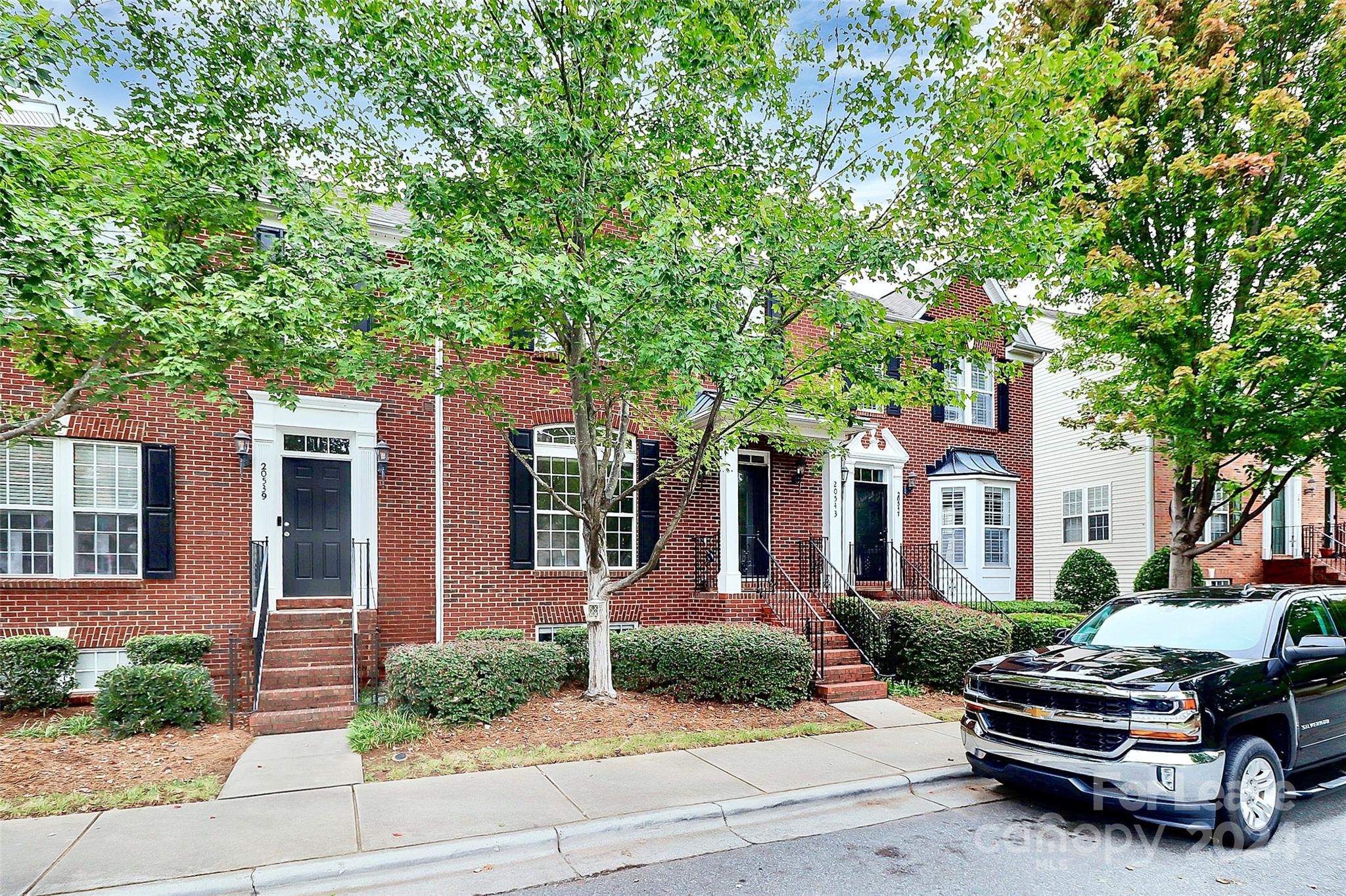 a car parked in front of a brick house