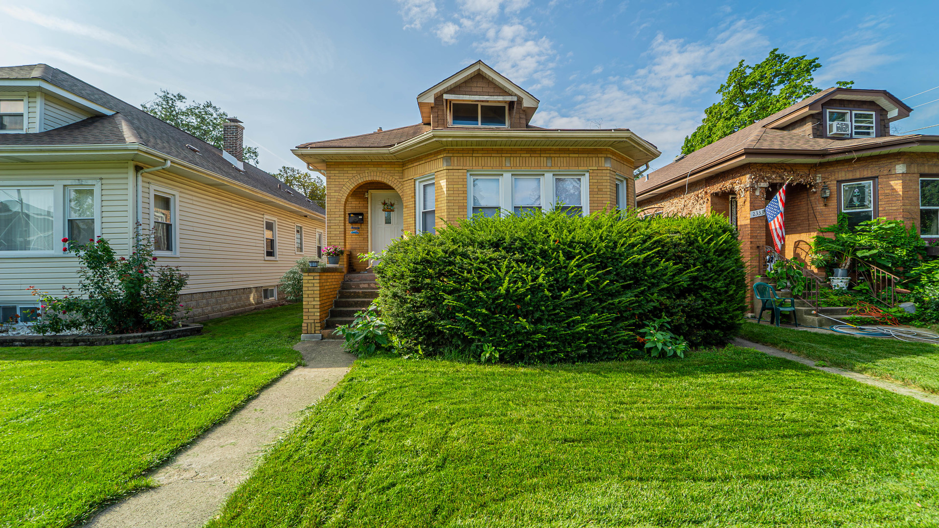 a front view of a house with a garden