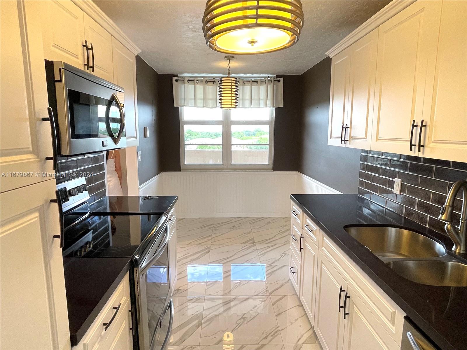 a kitchen with a stove a sink and a refrigerator