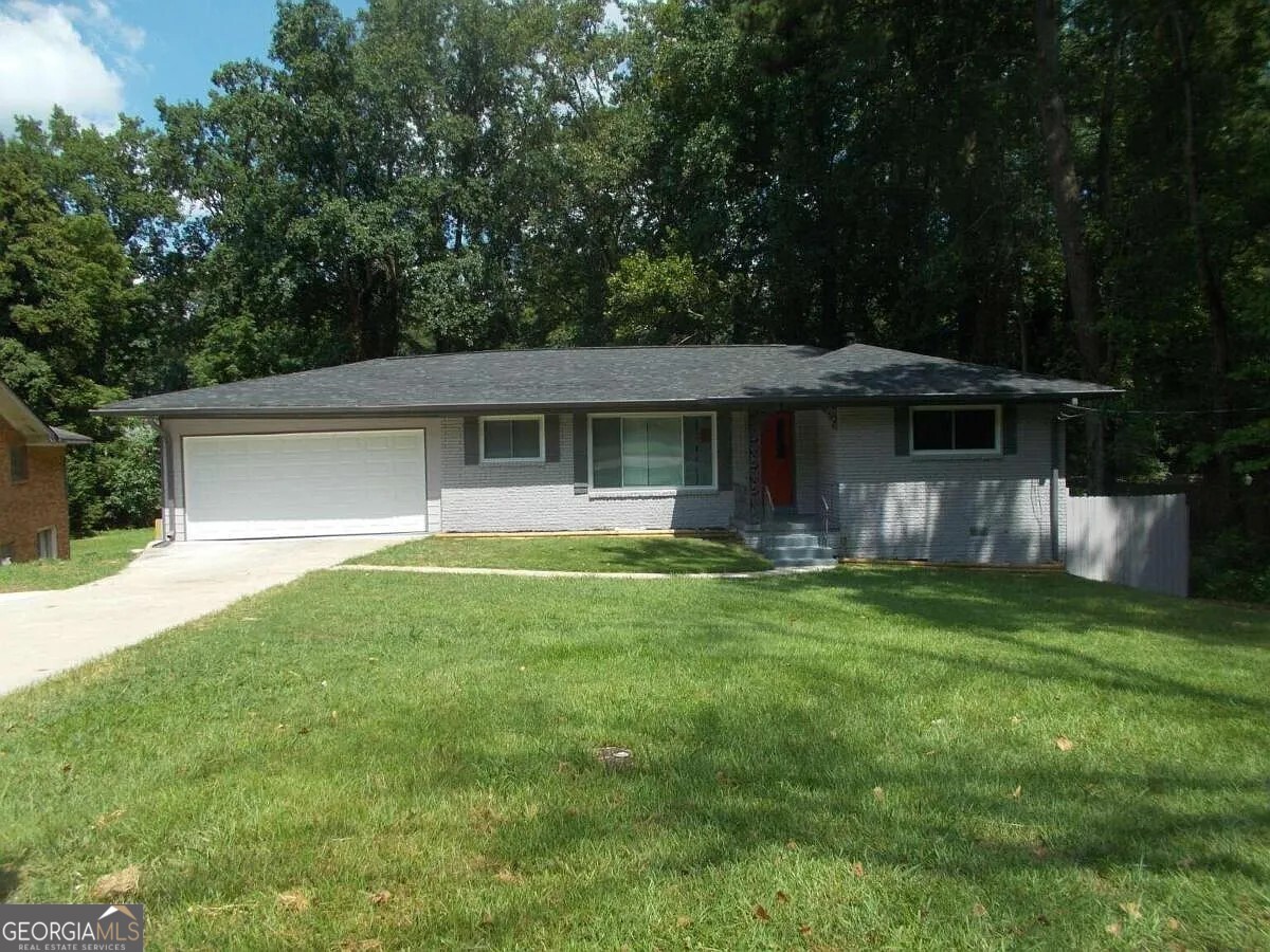 a front view of a house with a garden