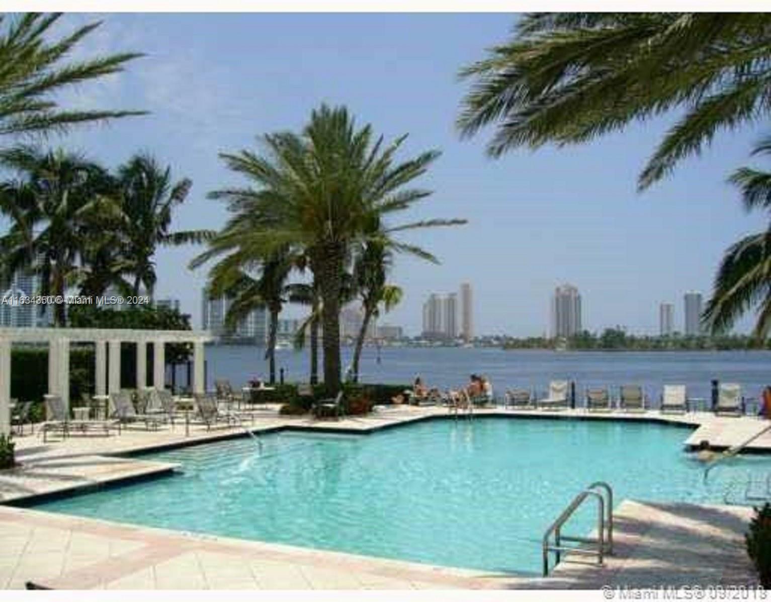 a swimming pool with outdoor seating and yard