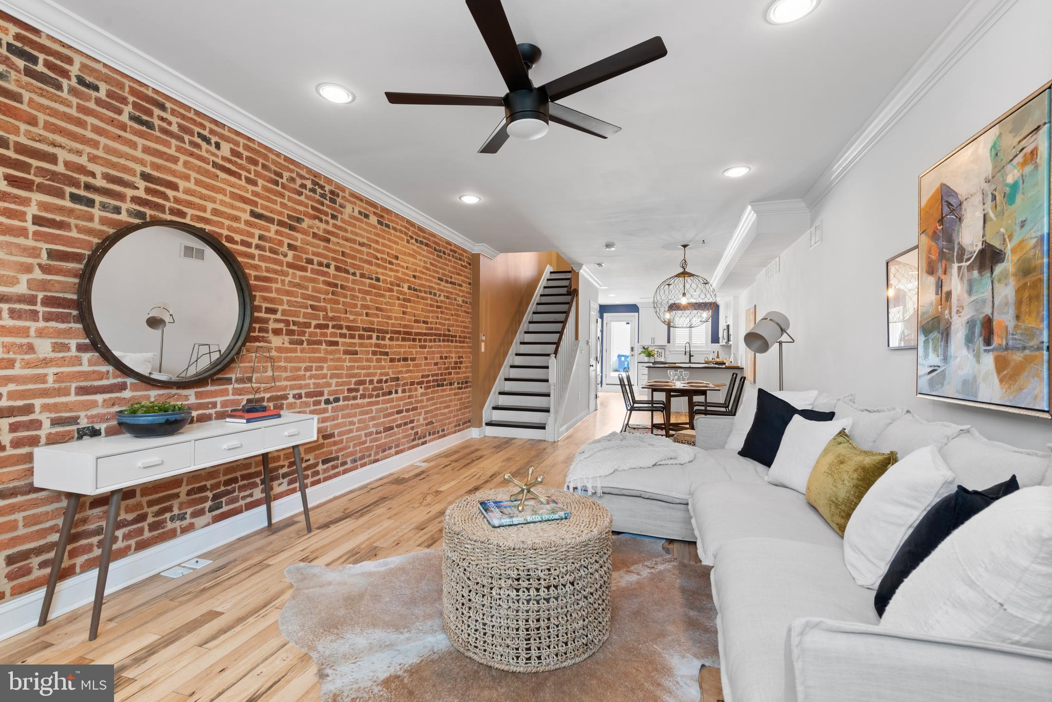 a living room with furniture a rug and a wall painting