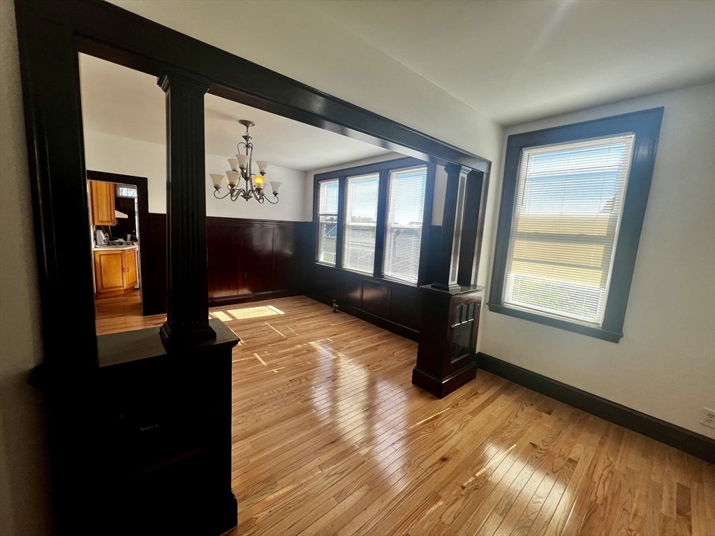 a bedroom with furniture and a wooden floor