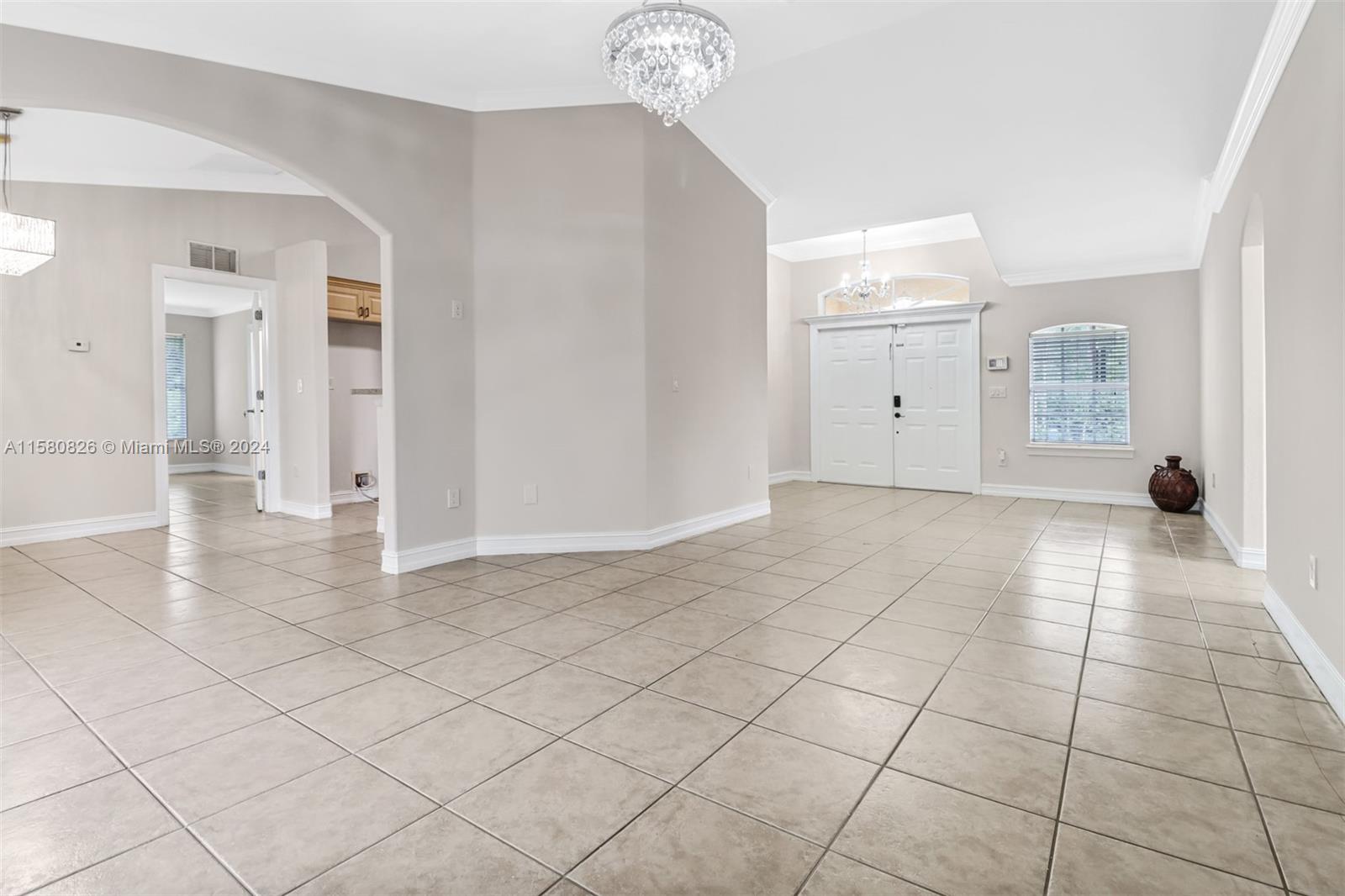 a view of a livingroom with an empty space and a window