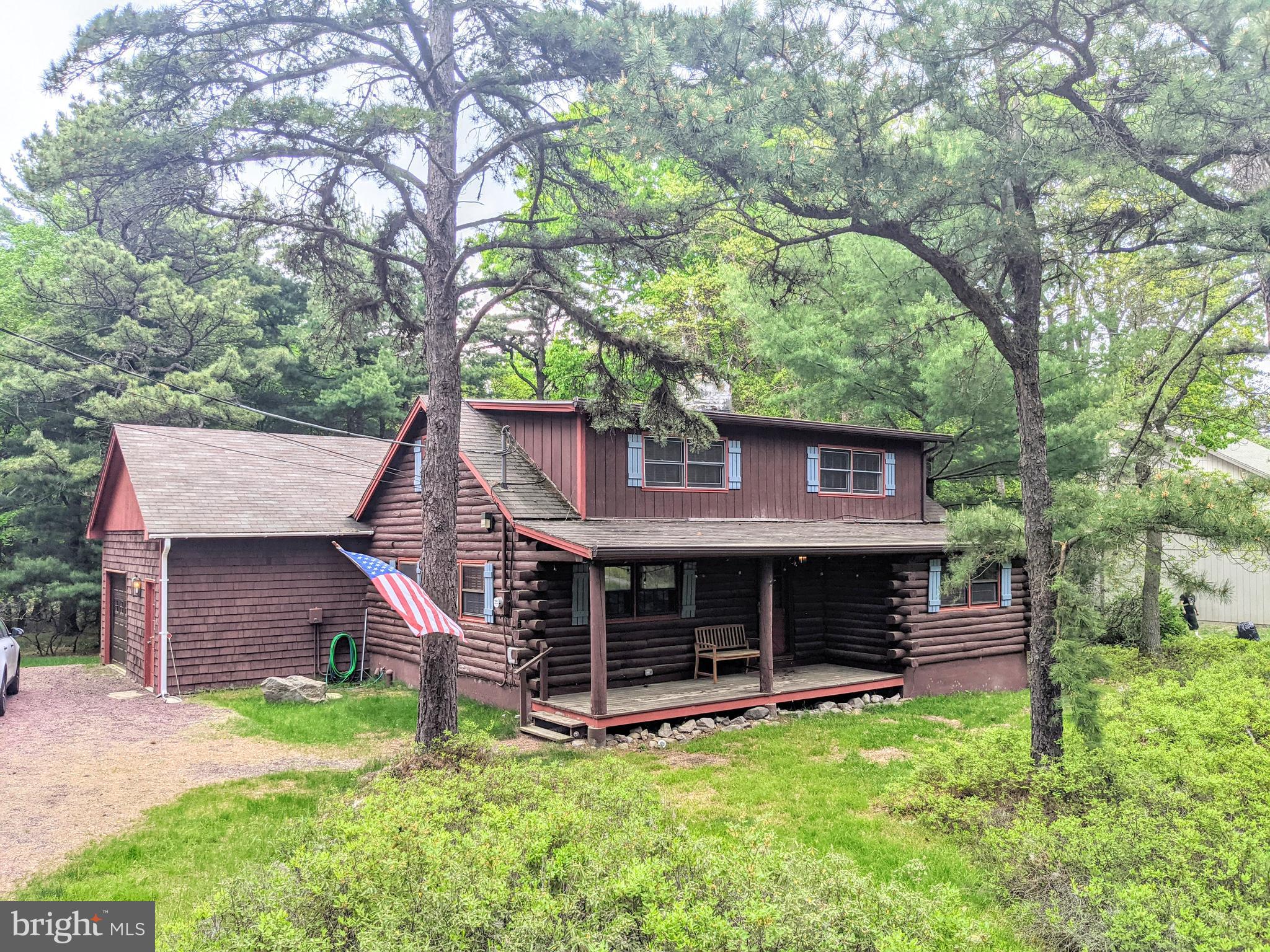 a view of a house with a yard and tree