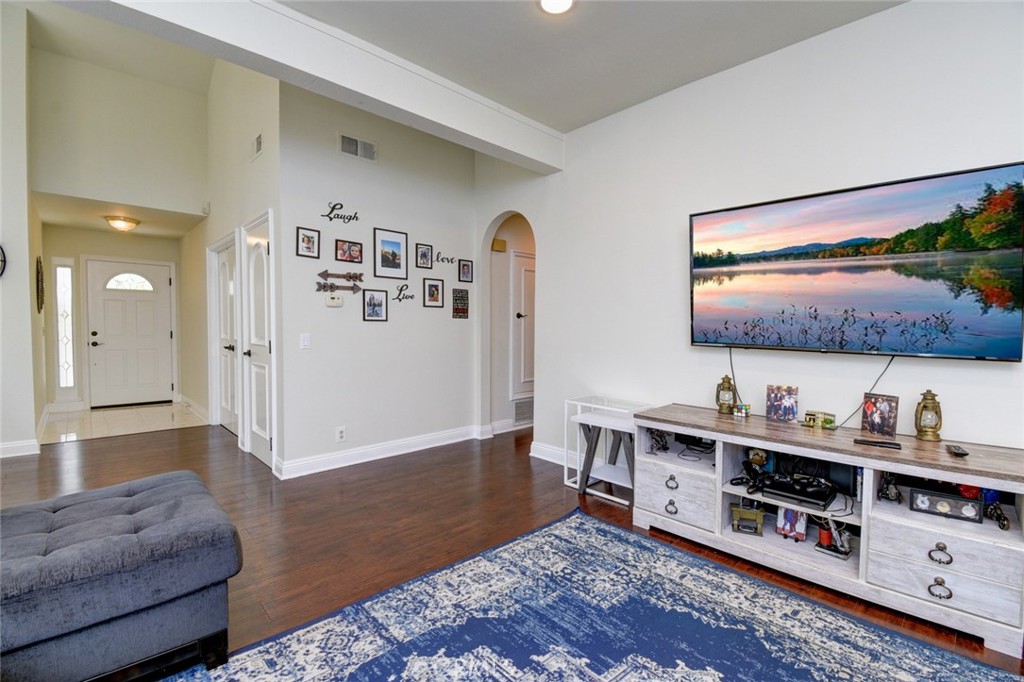 a living room with furniture and painting on the wall