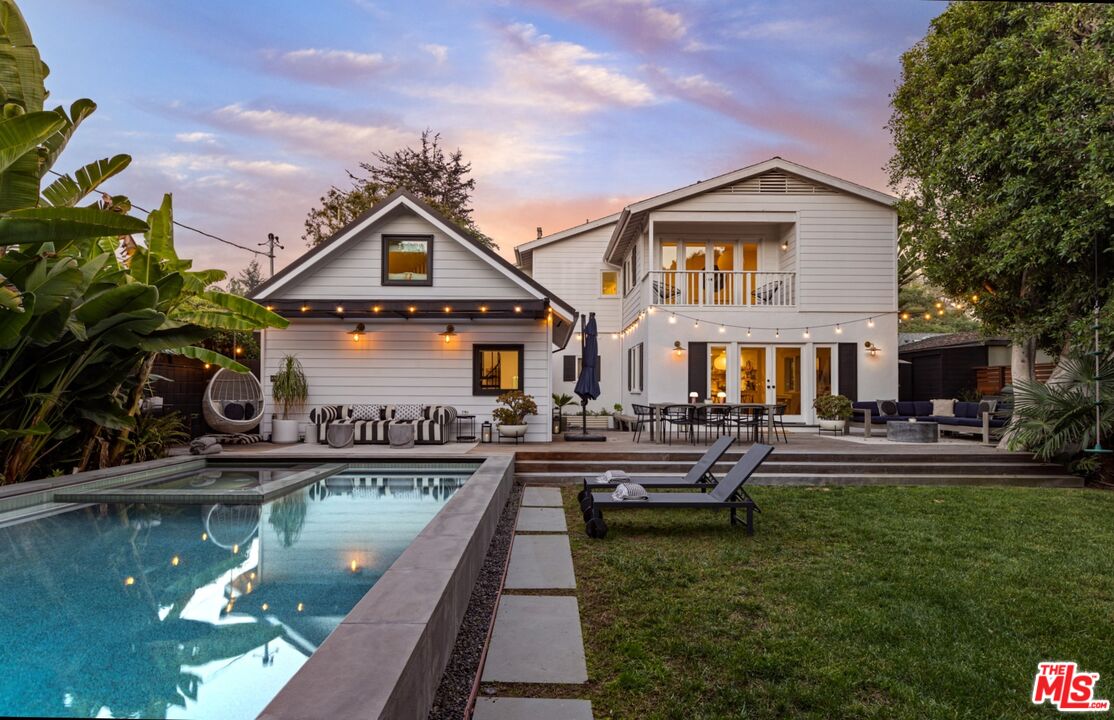 a front view of house with yard and outdoor seating