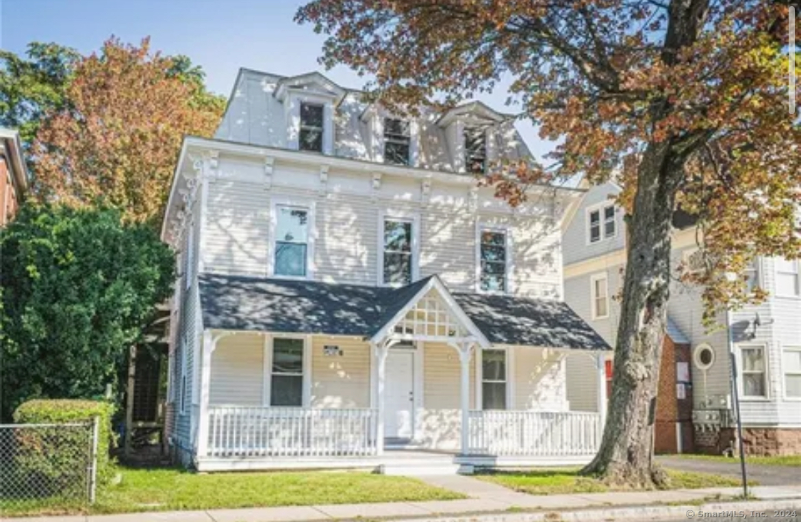 a front view of a house with a garden