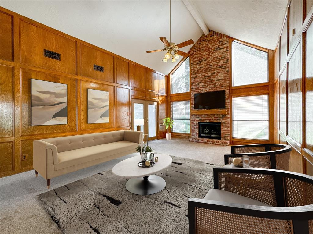 a living room with fireplace furniture and a floor to ceiling window