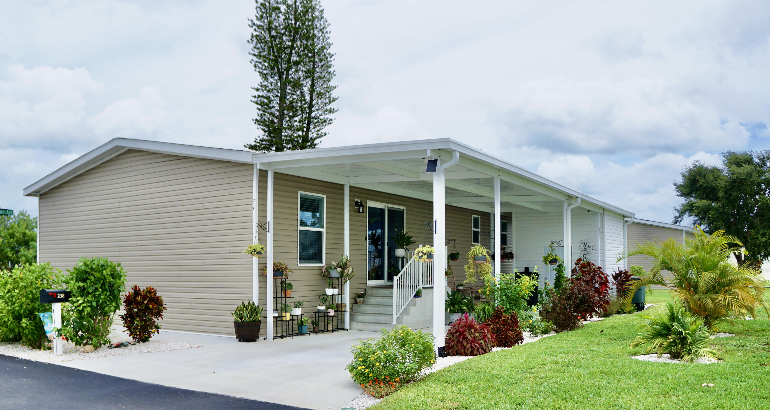 a front view of a house with a garden