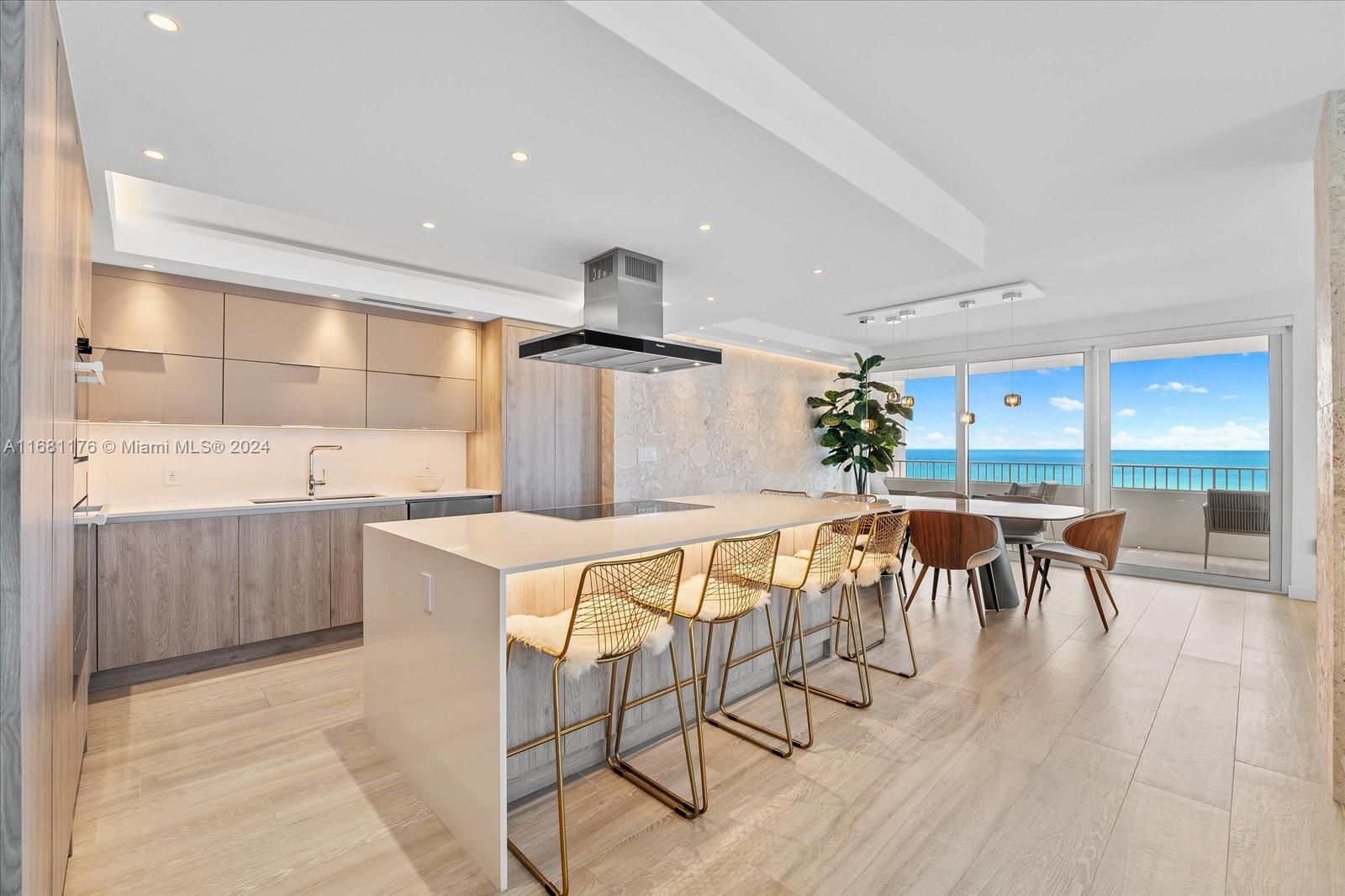 a kitchen with stainless steel appliances a table chairs refrigerator and cabinets