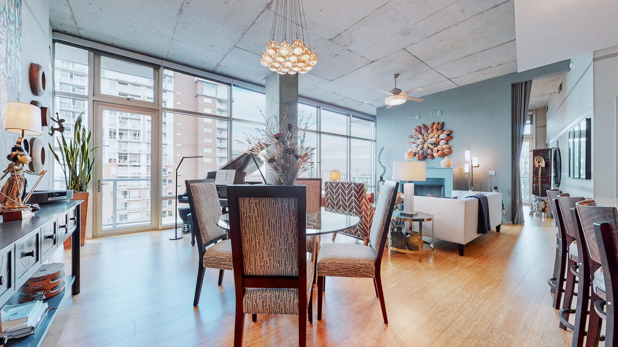 a dining room with furniture a chandelier and wooden floor