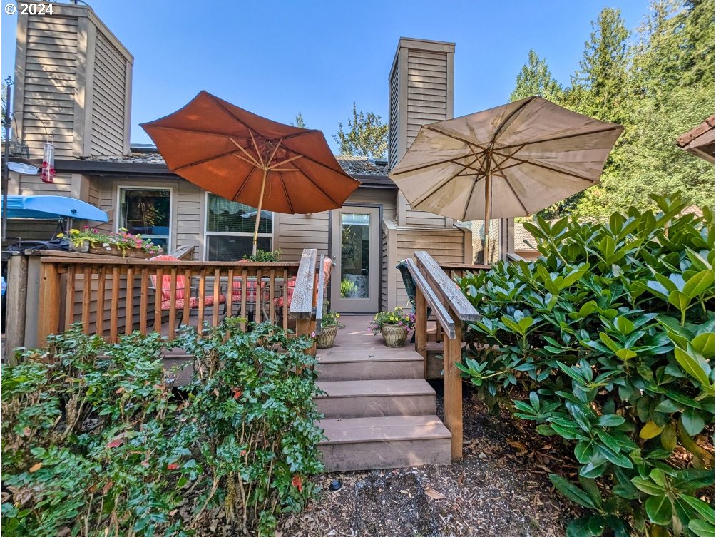 a view of a patio with a table and chairs under an umbrella