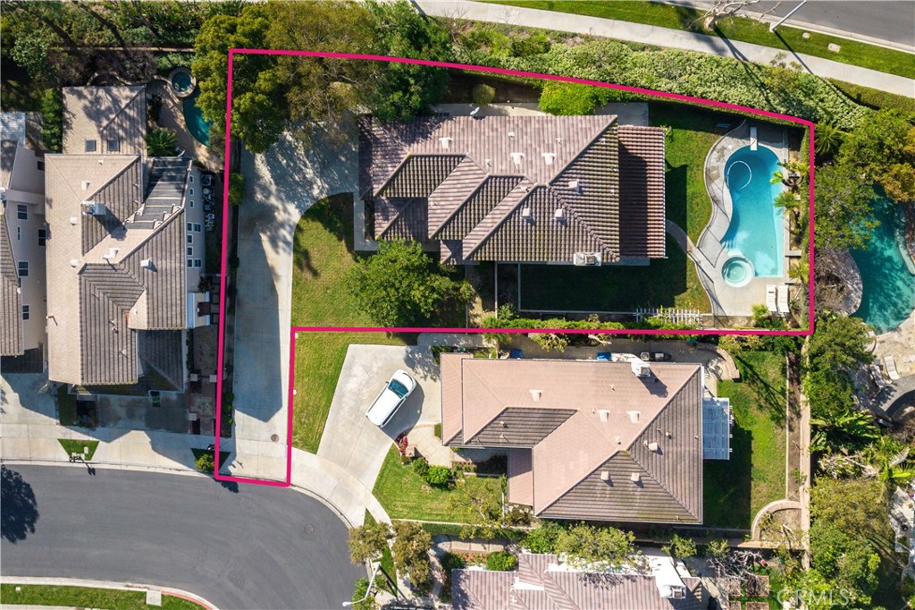 an aerial view of a house with swimming pool and outdoor seating