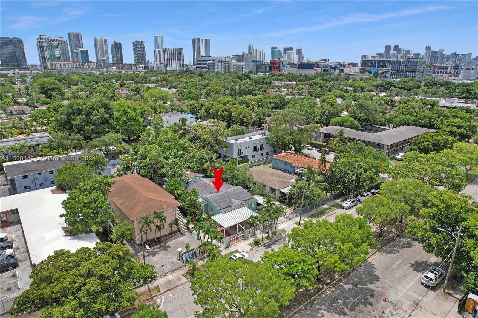 an aerial view of residential house with outdoor space and trees all around