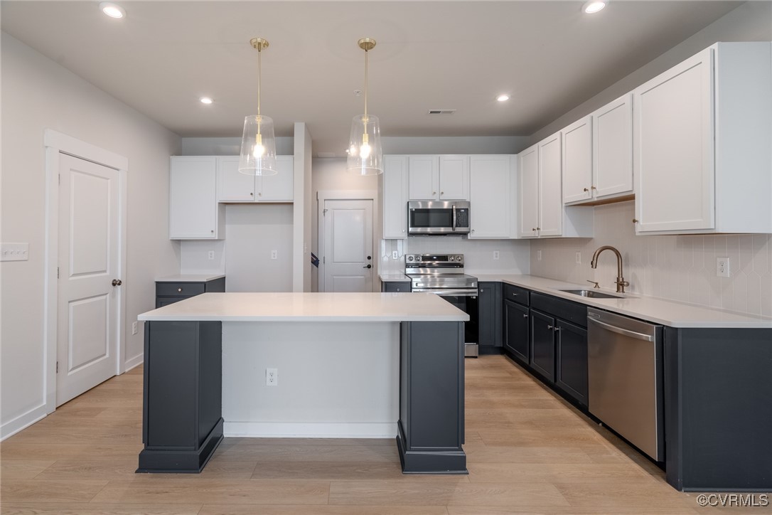 a kitchen with kitchen island cabinets and wooden floor