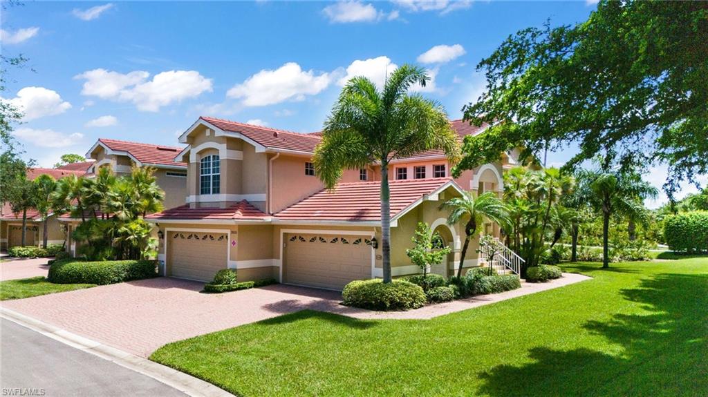 Mediterranean / spanish home with a garage and a front yard