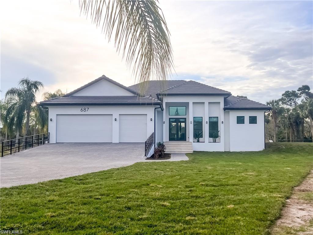 a front view of a house with a yard and garage