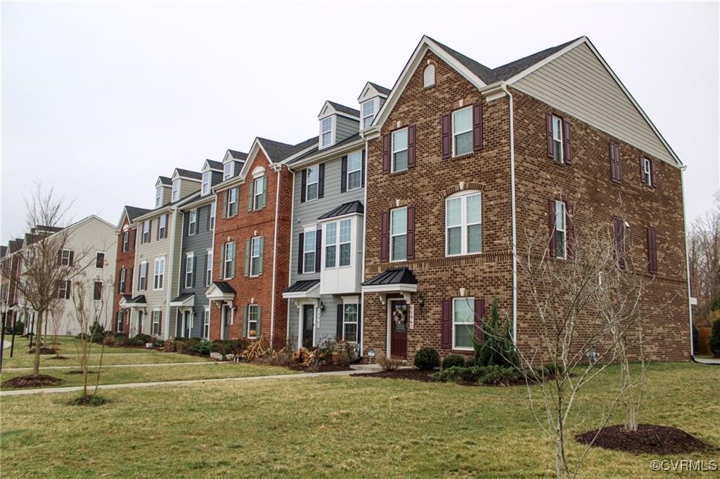 a front view of a residential apartment building with a yard