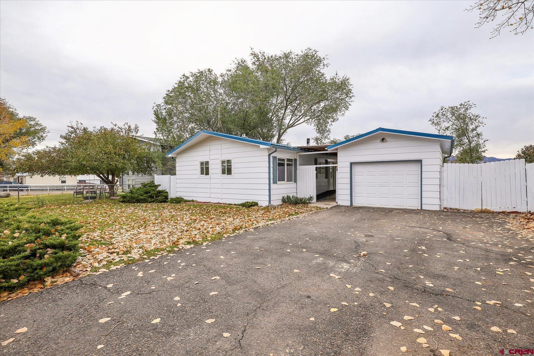 a view of a house with a yard and garage