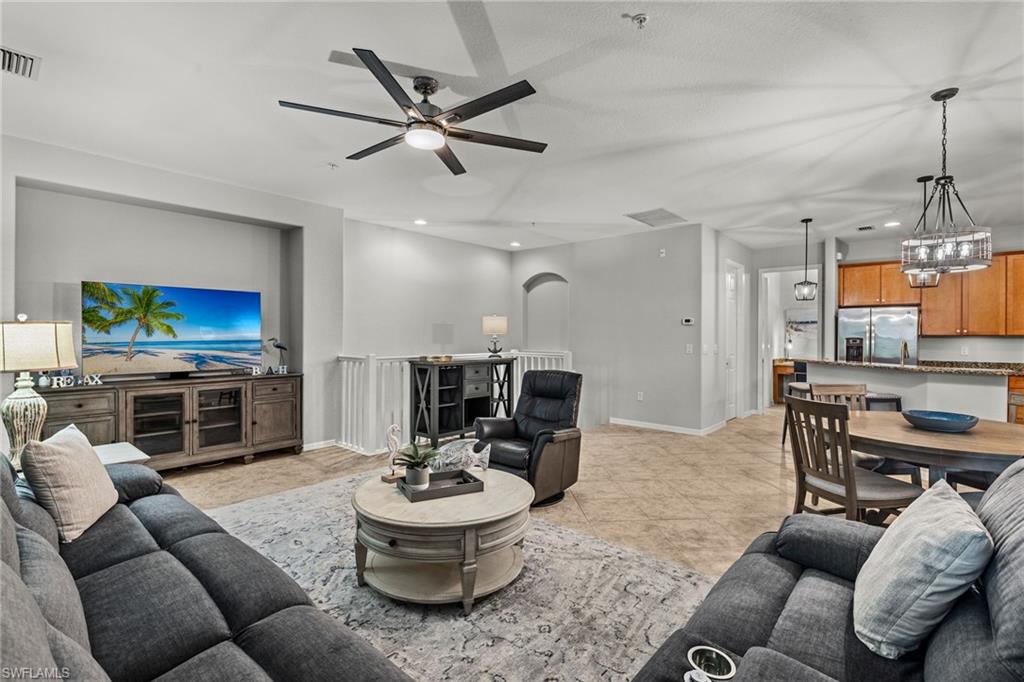 a living room with furniture a rug and a flat screen tv