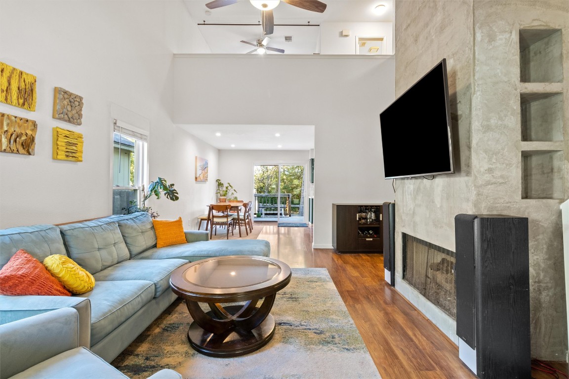 a living room with furniture a fireplace and a flat screen tv