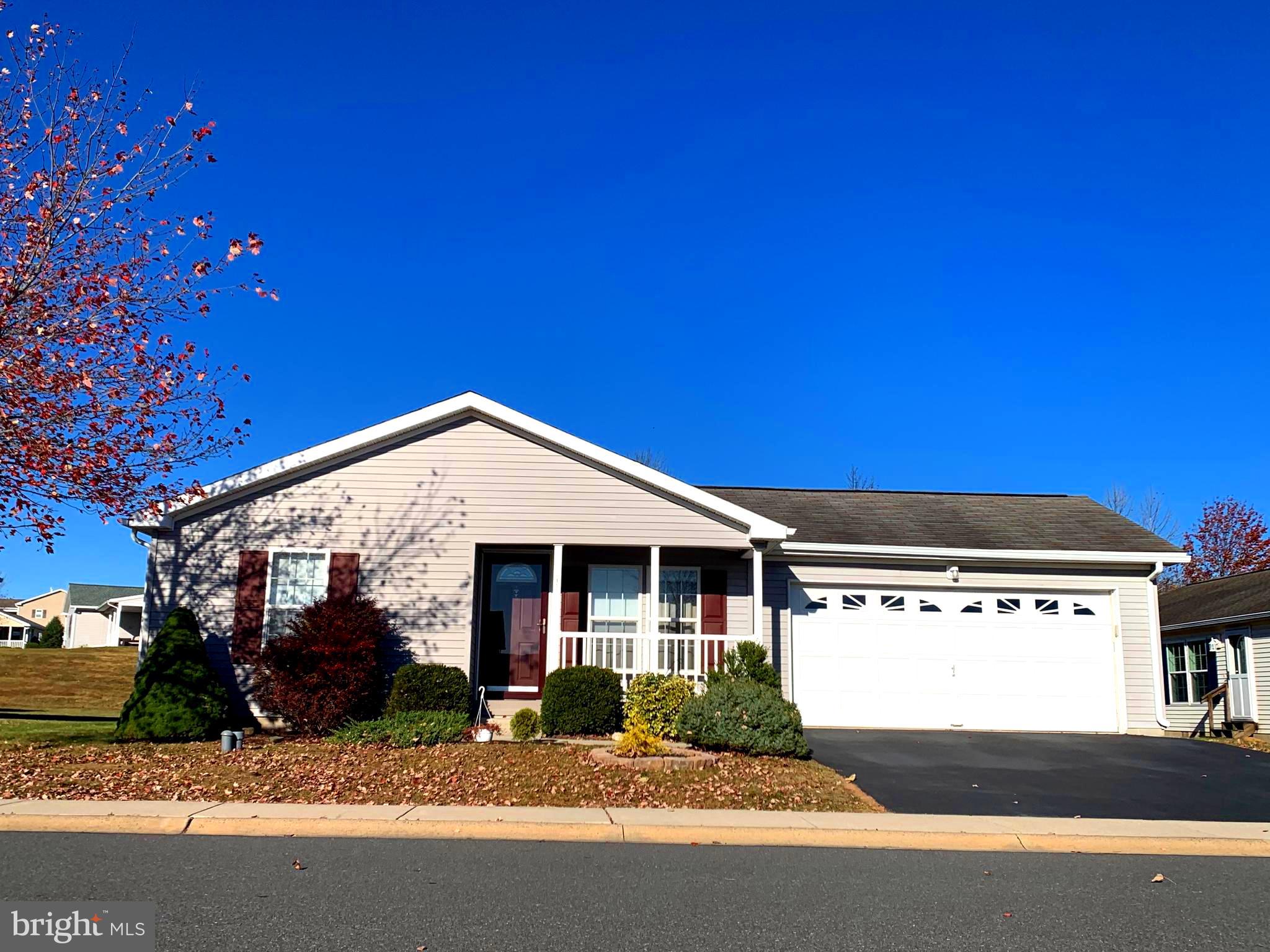 a front view of a house with a garden and yard