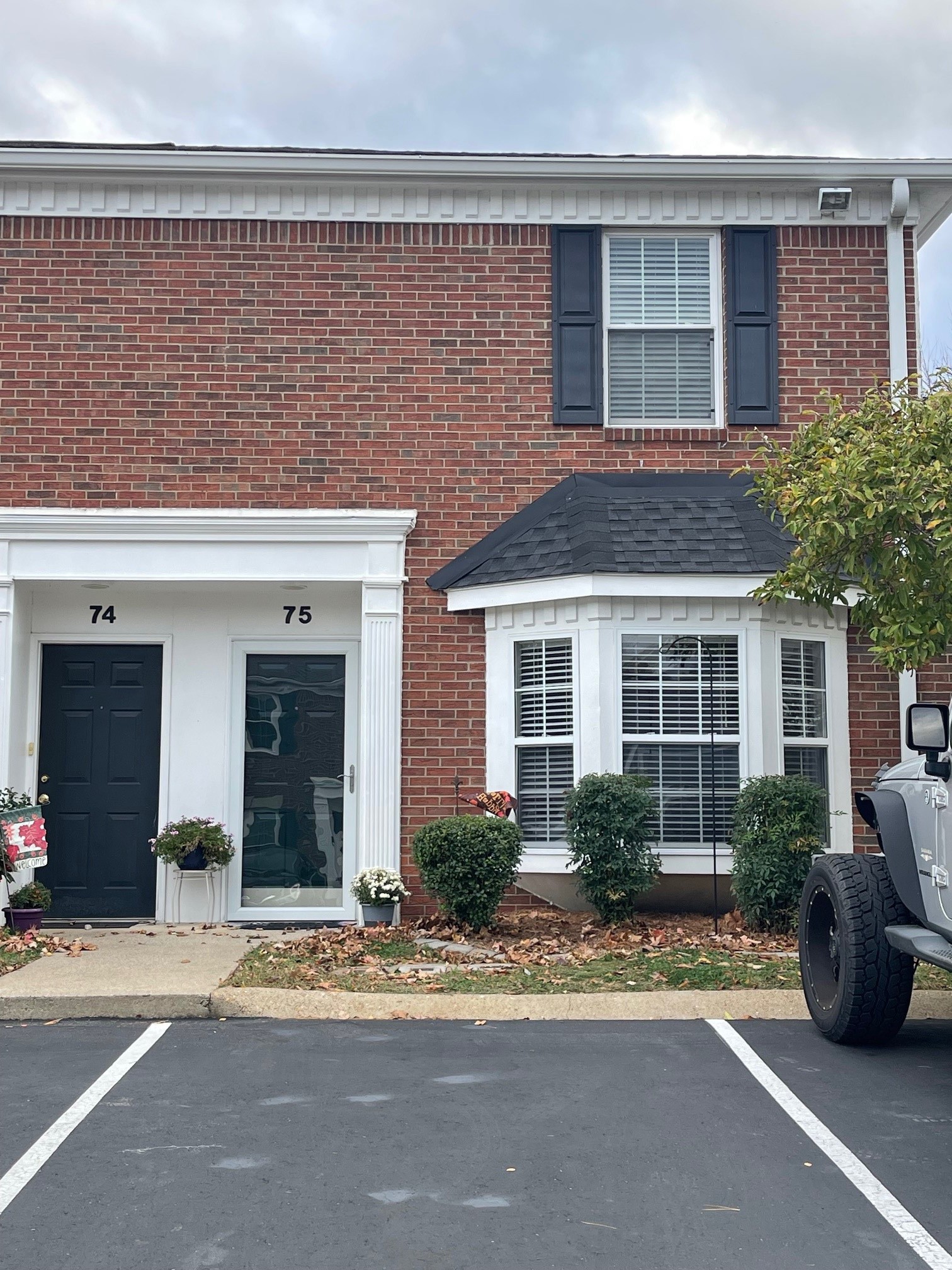 front view of a brick house with a patio