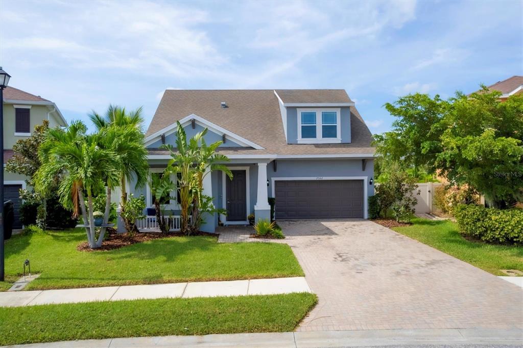 a front view of house with yard and green space