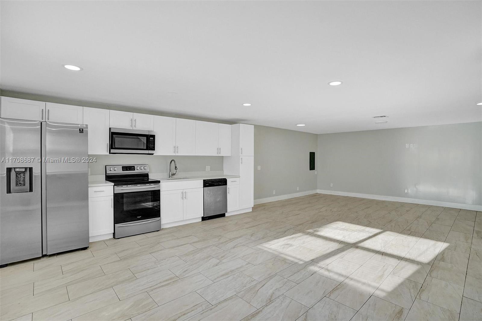 a kitchen with stainless steel appliances a refrigerator sink and stove