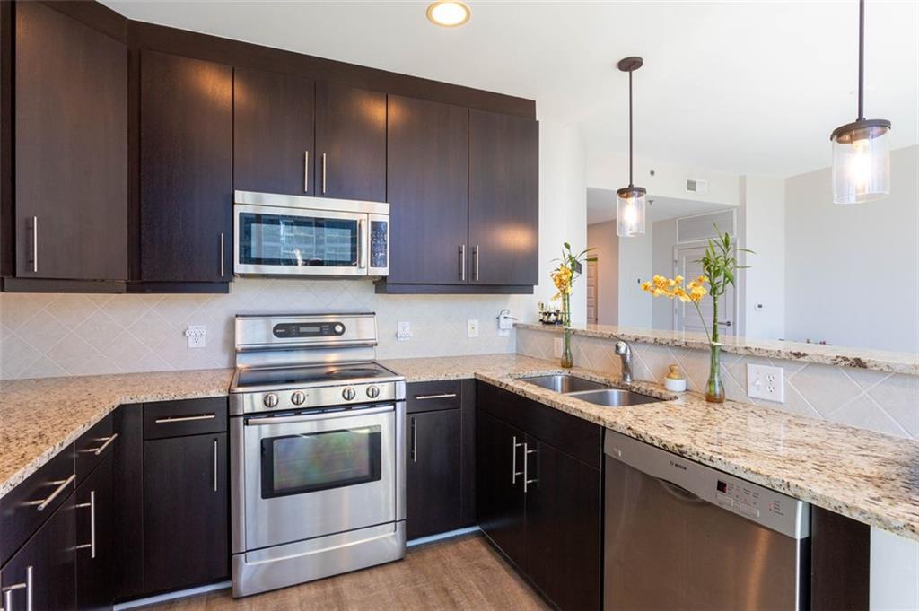 a kitchen with a sink stove and microwave