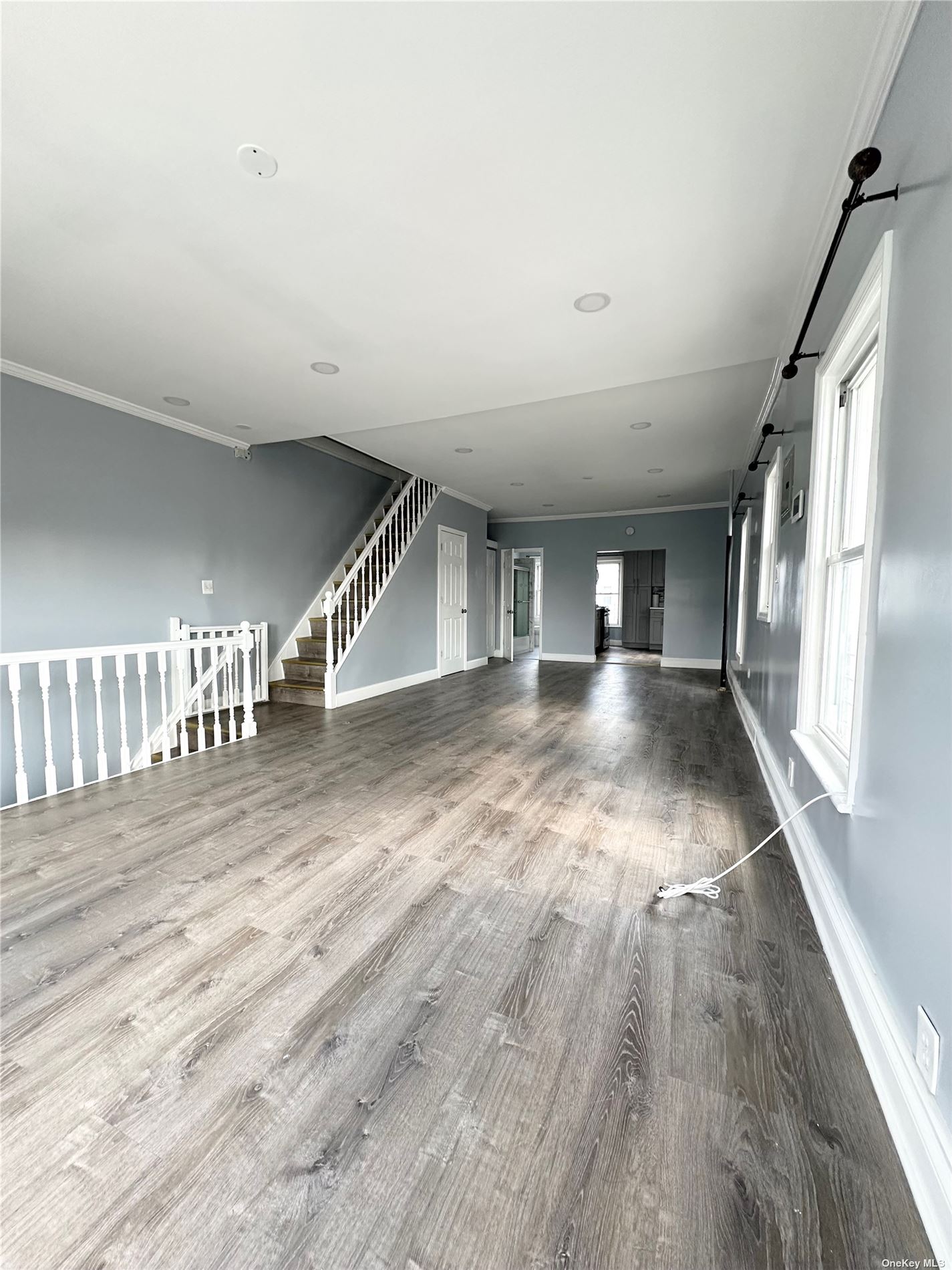 a view of empty room with wooden floor