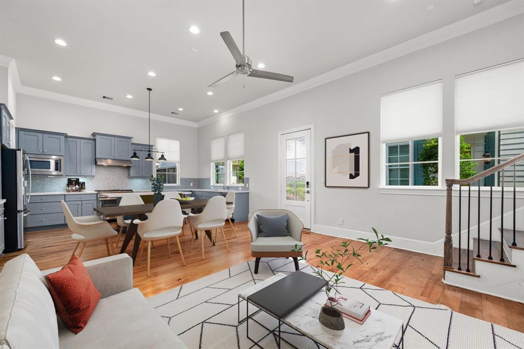 a living room with lots of furniture and kitchen view