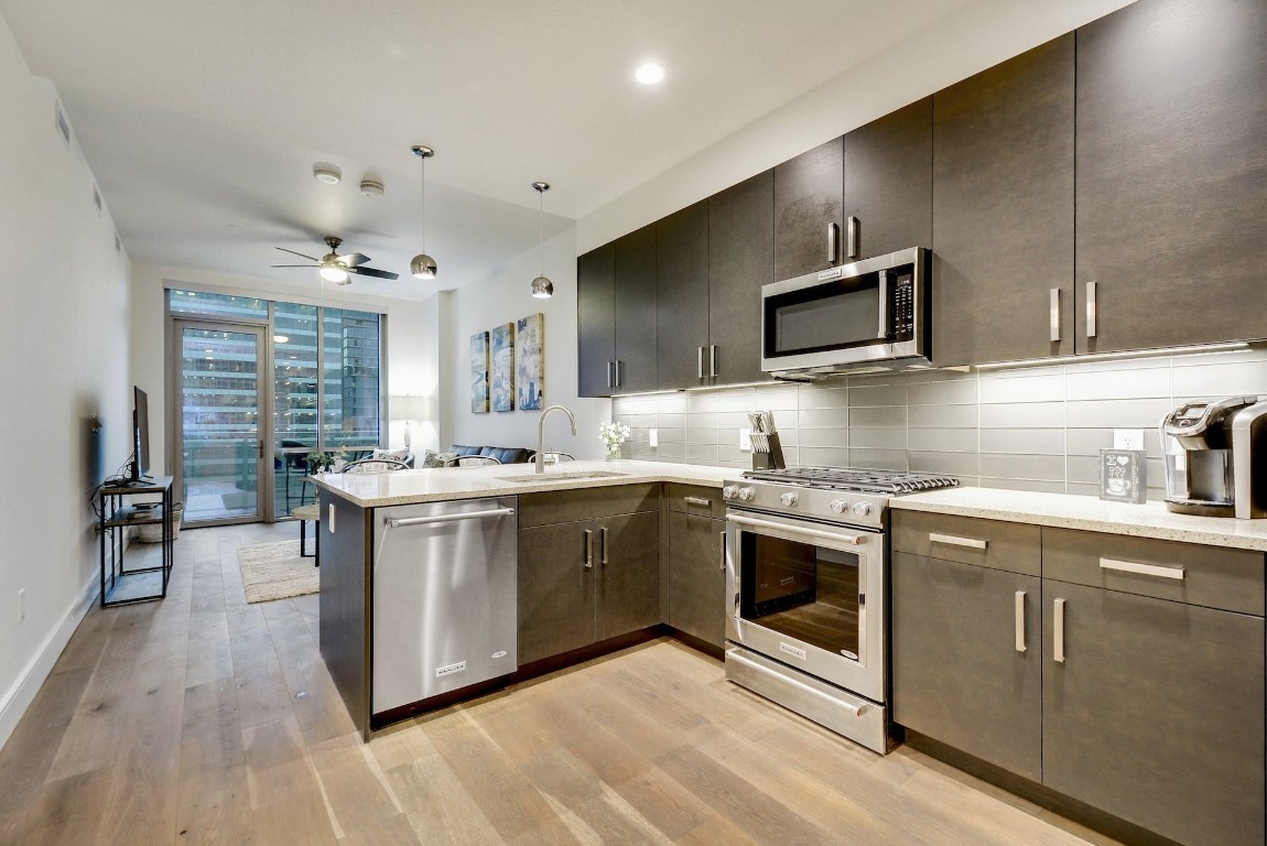 a kitchen with a sink stove and cabinets