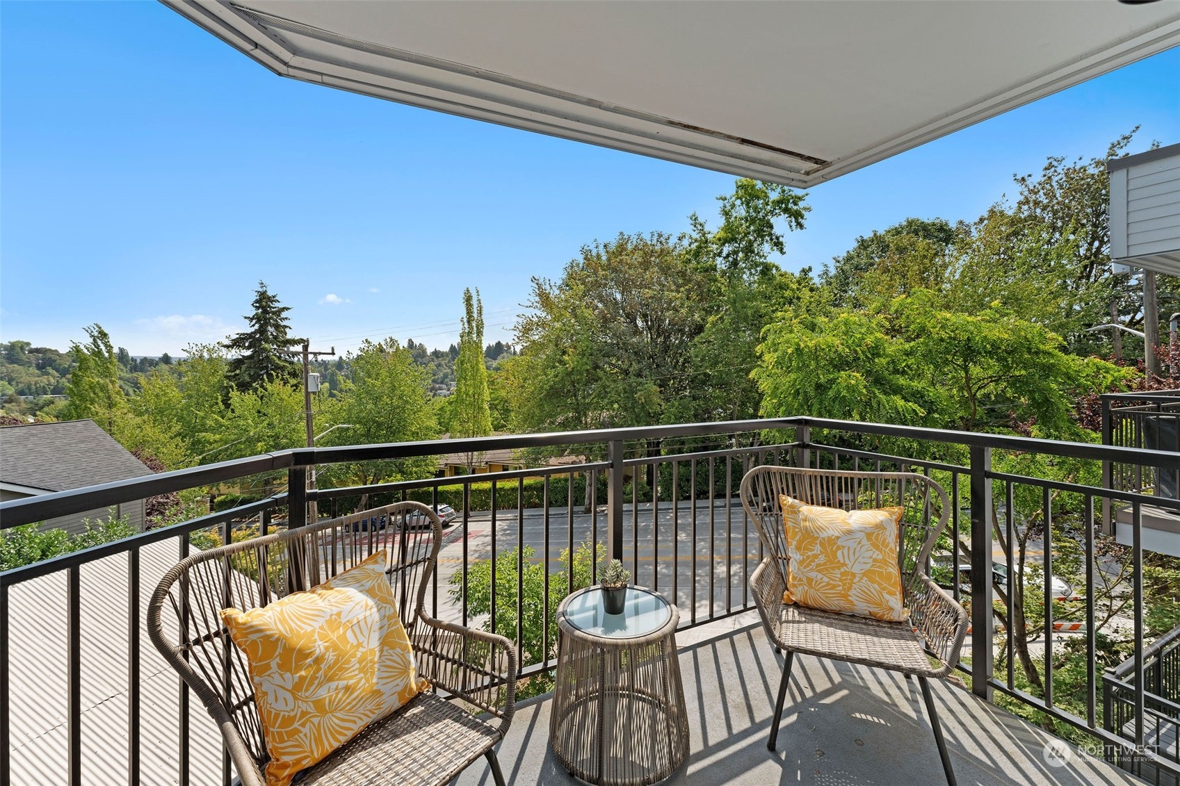 a view of a balcony with chair and wooden floor